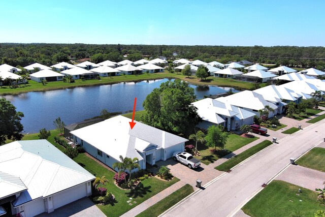 birds eye view of property with a residential view and a water view