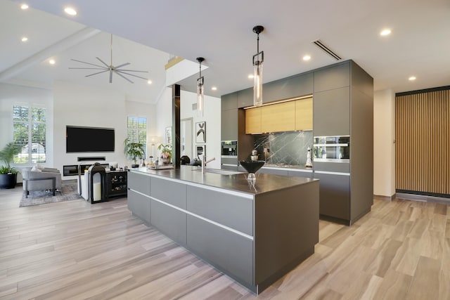 kitchen with light wood-style floors, modern cabinets, visible vents, and gray cabinetry