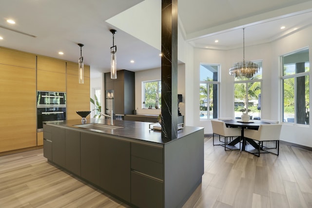 kitchen with a spacious island, stainless steel double oven, plenty of natural light, and modern cabinets