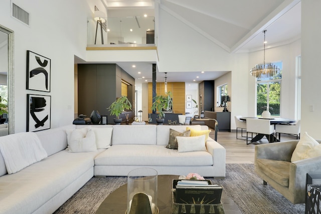 living room featuring visible vents, high vaulted ceiling, light wood-style flooring, recessed lighting, and a notable chandelier