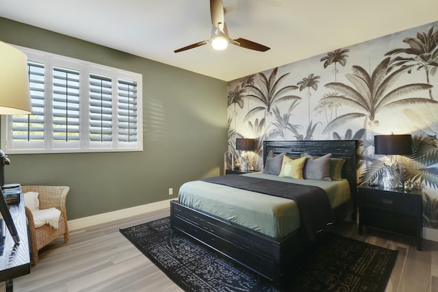 bedroom with wood finished floors, baseboards, and ceiling fan