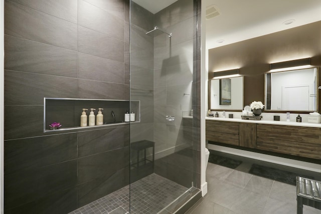 bathroom with visible vents, toilet, a shower stall, tile patterned flooring, and double vanity