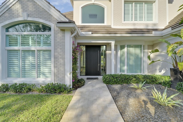 property entrance featuring brick siding