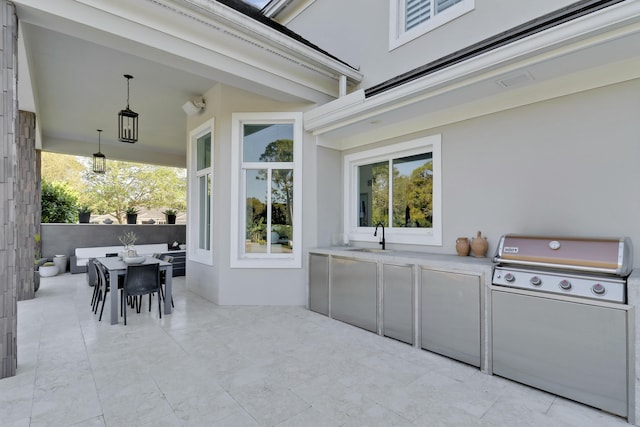 view of patio featuring outdoor dining space, a grill, exterior kitchen, and a sink