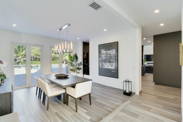 dining room with light wood finished floors, visible vents, recessed lighting, and french doors