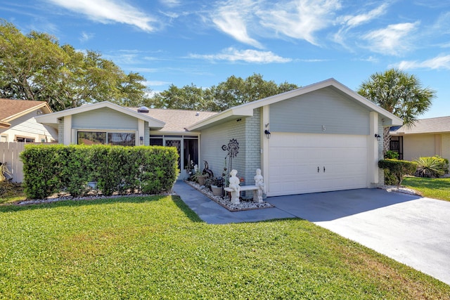 single story home featuring a front yard, concrete driveway, and an attached garage