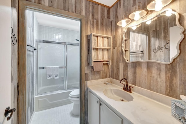 full bathroom featuring tile patterned floors, enclosed tub / shower combo, toilet, and vanity