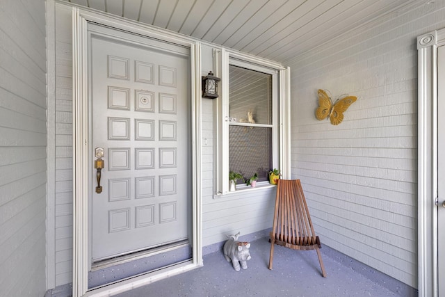 view of exterior entry with covered porch