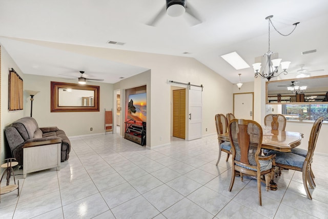 dining area with visible vents, ceiling fan with notable chandelier, a barn door, and vaulted ceiling