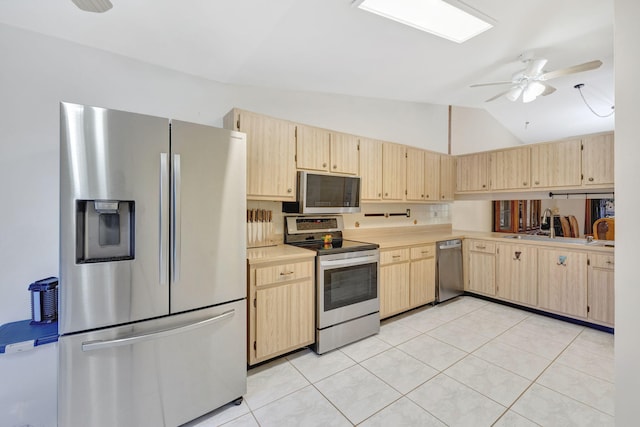 kitchen with a ceiling fan, light countertops, light brown cabinets, and stainless steel appliances