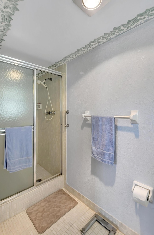 full bath with tile patterned floors and a stall shower