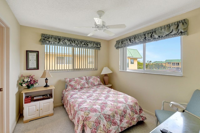 bedroom with baseboards, carpet, ceiling fan, and a textured ceiling