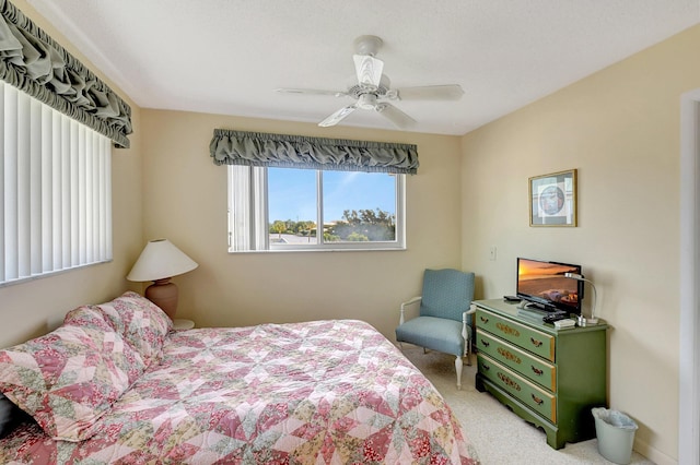 bedroom with light colored carpet and ceiling fan