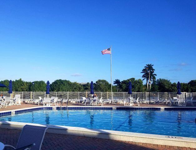 view of swimming pool featuring a patio area and fence