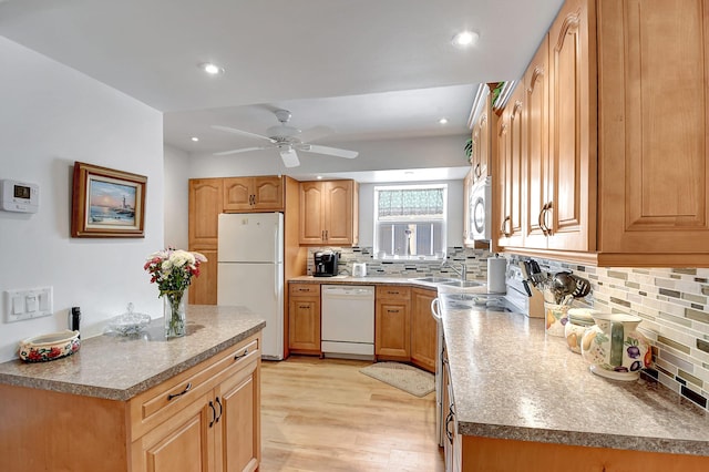 kitchen with decorative backsplash, recessed lighting, white appliances, and light wood-type flooring