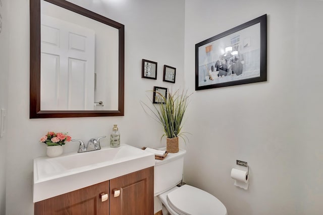 half bathroom featuring toilet and vanity