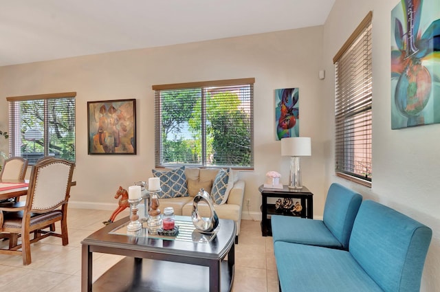 living room featuring light tile patterned floors and baseboards