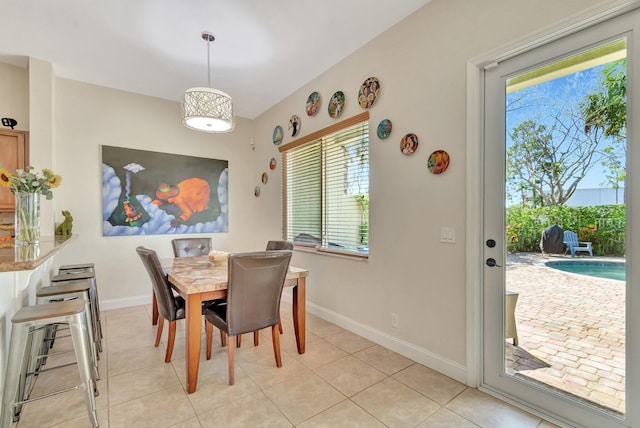 dining area with light tile patterned flooring and baseboards