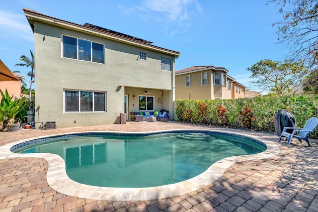 view of pool with a fenced in pool, fence, ceiling fan, outdoor lounge area, and a patio area