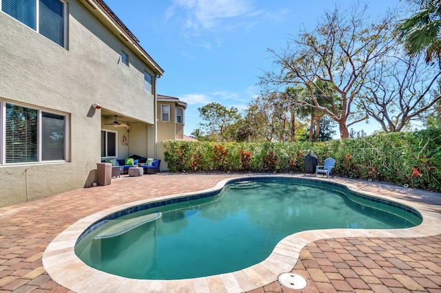 view of swimming pool with an outdoor living space, a fenced backyard, a fenced in pool, ceiling fan, and a patio area