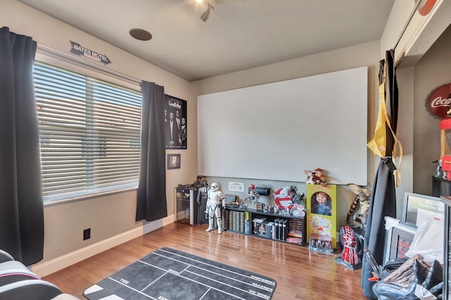 recreation room with wood finished floors and baseboards