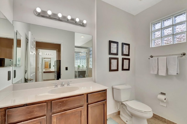 full bath with vanity, toilet, a stall shower, and a wealth of natural light