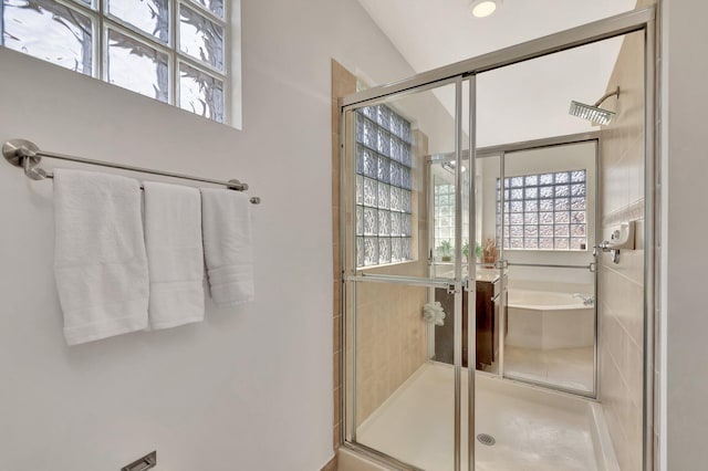 bathroom with a shower stall and a garden tub