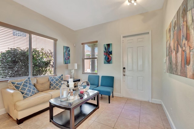 living room featuring light tile patterned floors and baseboards