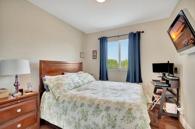 bedroom with baseboards and dark wood-style flooring