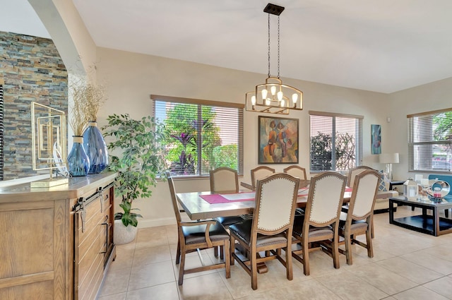 dining room featuring a wealth of natural light, a chandelier, and light tile patterned floors