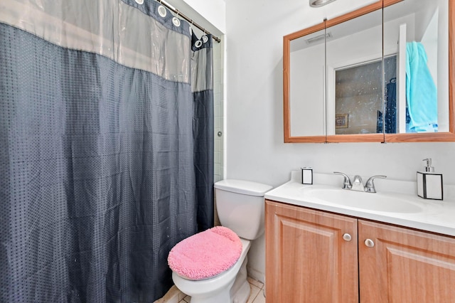 bathroom featuring vanity, toilet, a shower with curtain, and visible vents