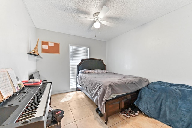 bedroom with light tile patterned flooring, a textured ceiling, and a ceiling fan