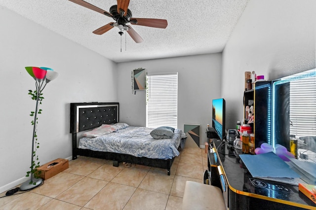 bedroom featuring ceiling fan, a textured ceiling, and light tile patterned flooring