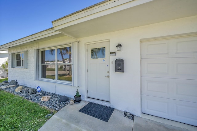 doorway to property with a garage
