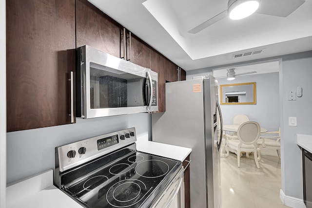 kitchen featuring light countertops, stainless steel appliances, visible vents, and dark brown cabinetry