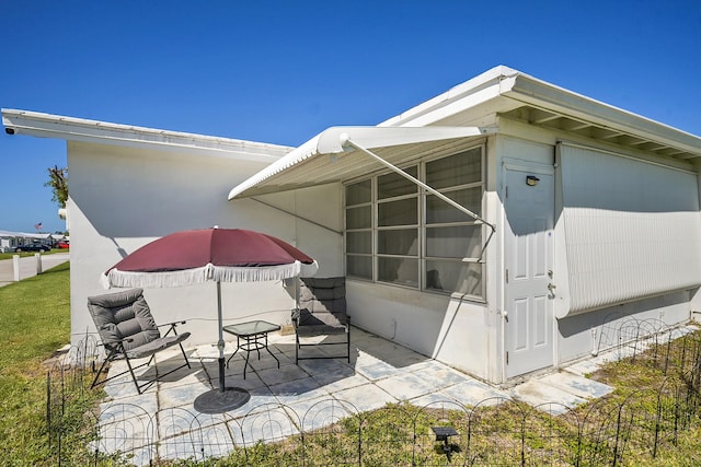 back of property featuring a patio