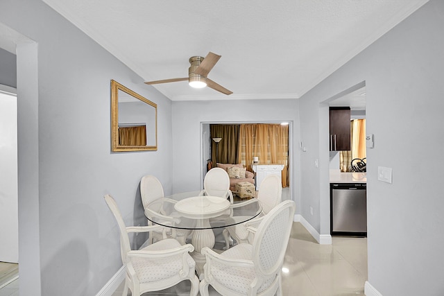 dining area with baseboards, crown molding, and ceiling fan