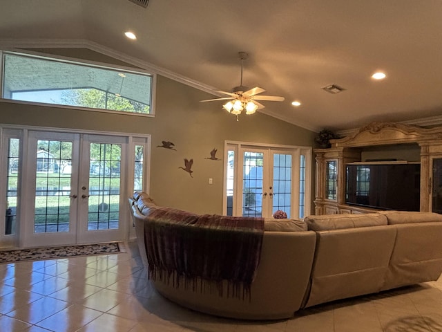 living room with a wealth of natural light, french doors, lofted ceiling, and light tile patterned flooring