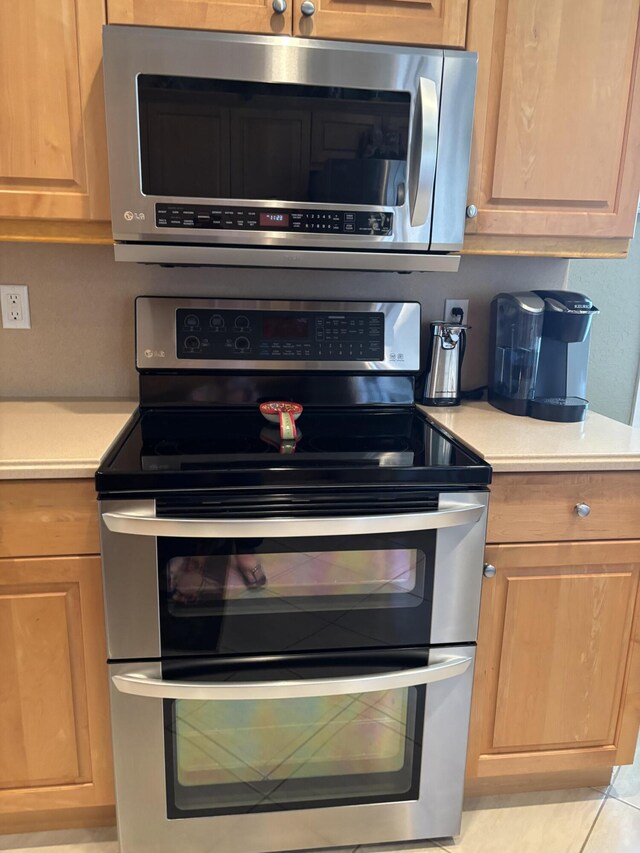 kitchen featuring appliances with stainless steel finishes and light countertops