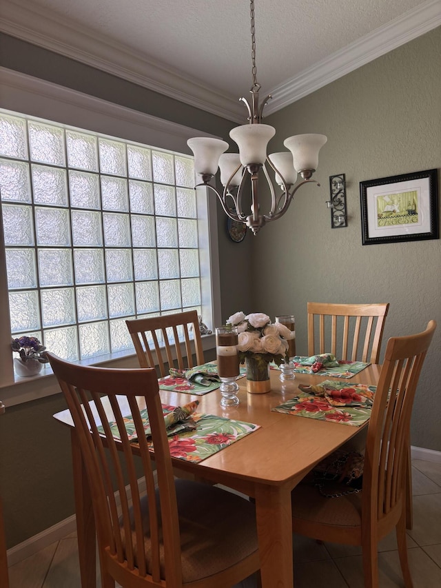 dining room featuring tile patterned flooring, crown molding, a textured wall, and a chandelier