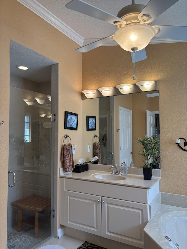 full bathroom featuring vanity, a shower stall, a textured ceiling, crown molding, and a textured wall