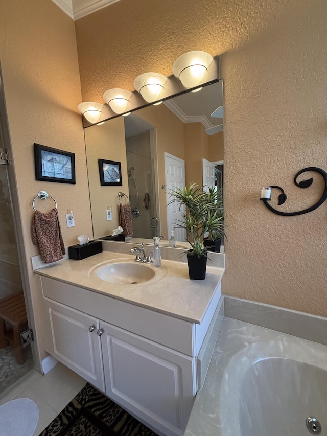 bathroom with a stall shower, ornamental molding, a bath, vanity, and a textured wall