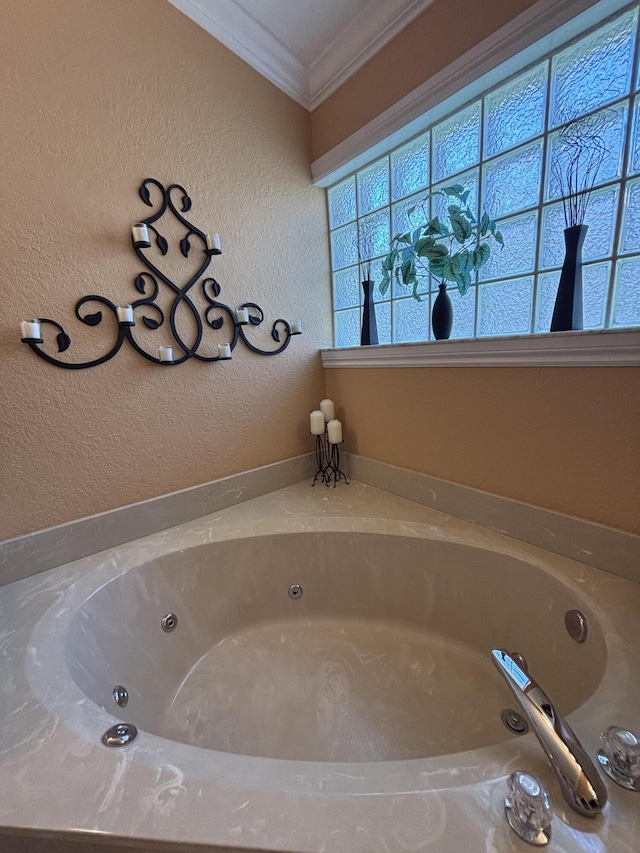 full bath with crown molding, a jetted tub, and a textured wall