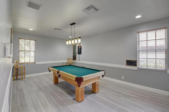 playroom featuring wood finished floors, visible vents, and baseboards