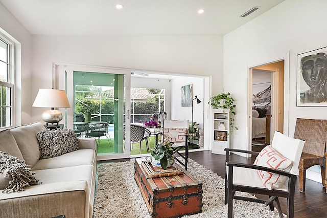 living room with dark wood finished floors, plenty of natural light, and recessed lighting