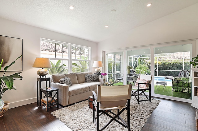 living area featuring lofted ceiling, a textured ceiling, recessed lighting, baseboards, and dark wood-style flooring