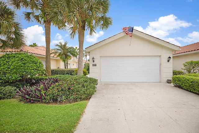 view of front of house featuring a garage, driveway, and stucco siding