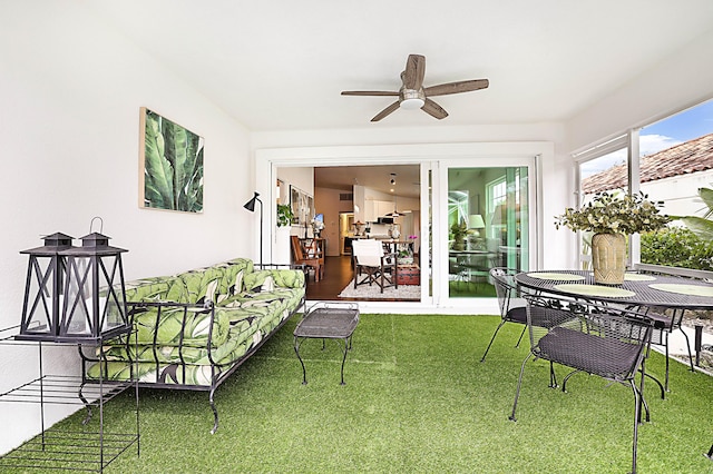 sunroom / solarium with a ceiling fan