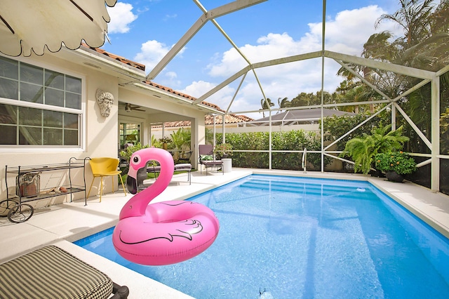 pool featuring a patio area and glass enclosure