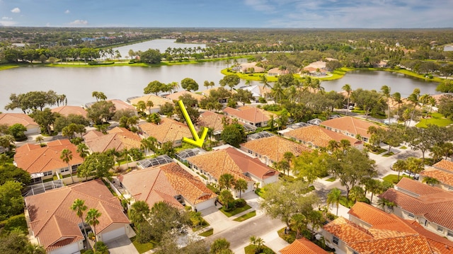 drone / aerial view with a residential view and a water view